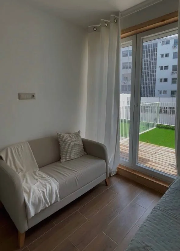 Bedroom with sofa and garden access